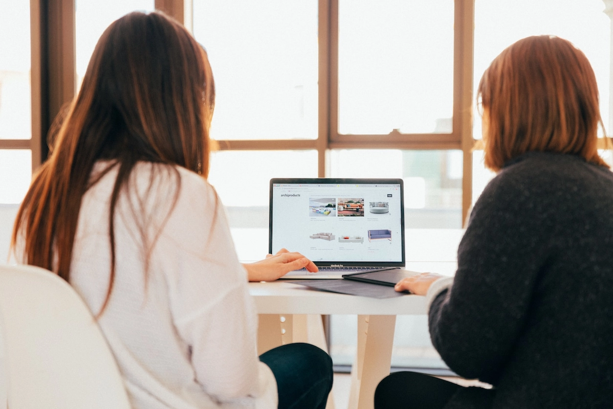 Two women checking MBAnalyst dashboards